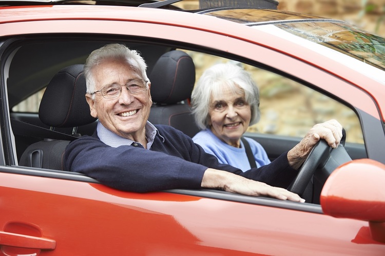 Elderly Couple Driving Car